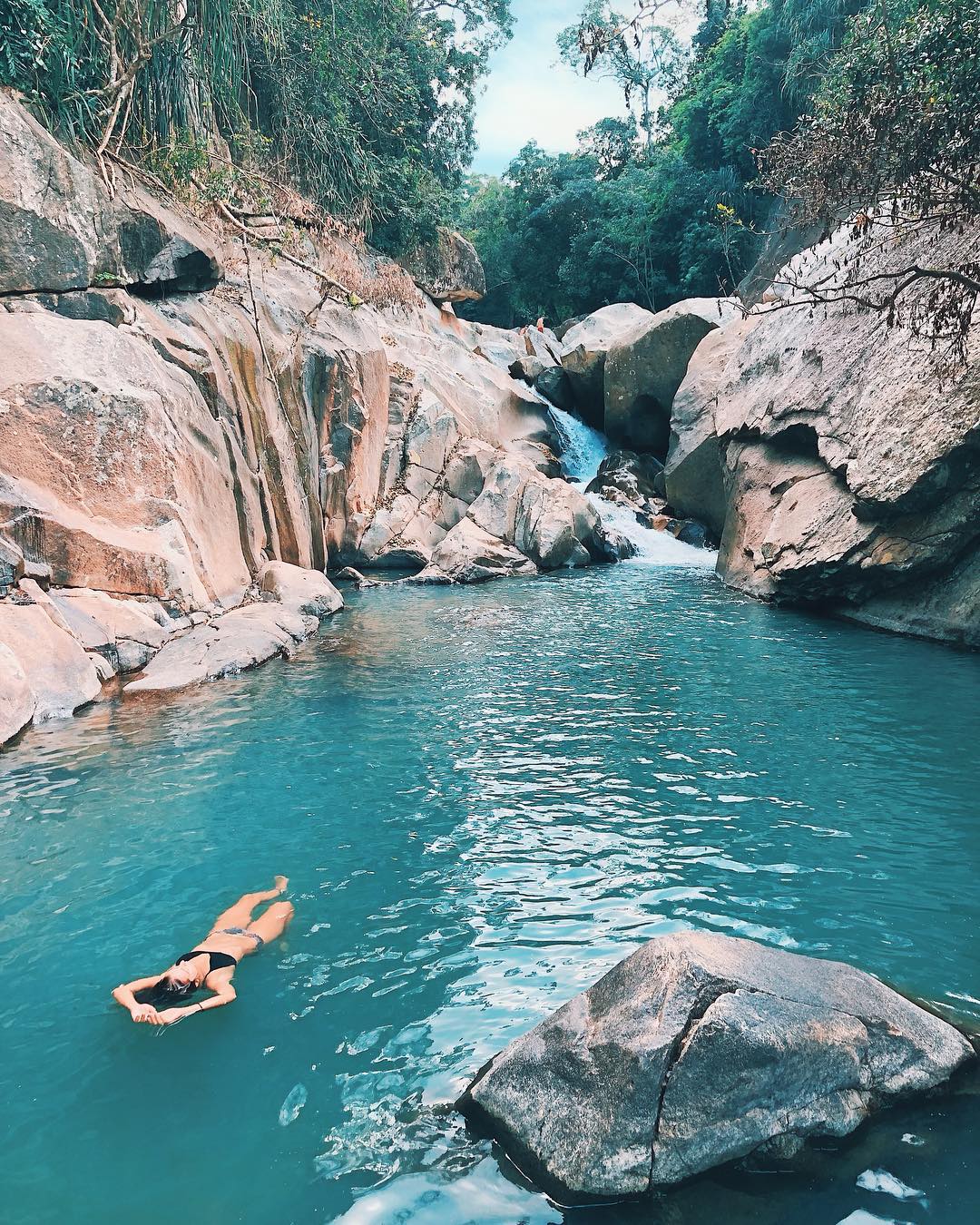 Take the plunge! Swimming in the crystal blue waters of Ba Ho is an amazing experience