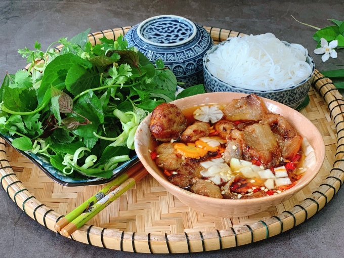 Savor the flavors of Vietnams culinary masterpiece – Bun Cha. Delicate noodles, succulent grilled pork, and the perfect blend of herbs and spices - cuisine of vietnam