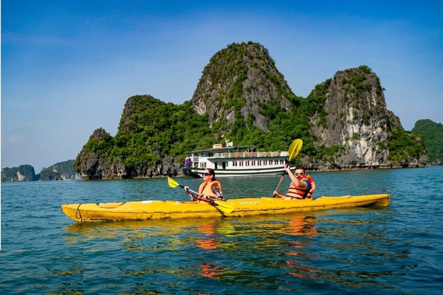 Paddle through the breathtaking limestone cliffs and hidden caves in Halong Bay with kayaking tour