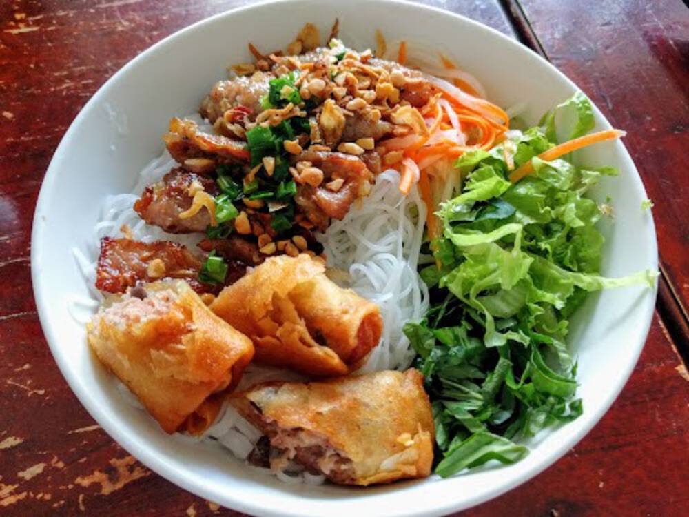 Spice up your life with some Bun Thit Nuong, This delicious Vietnamese dish is packed full of flavor and sure to tantalize your taste buds - ho chi minh food tour