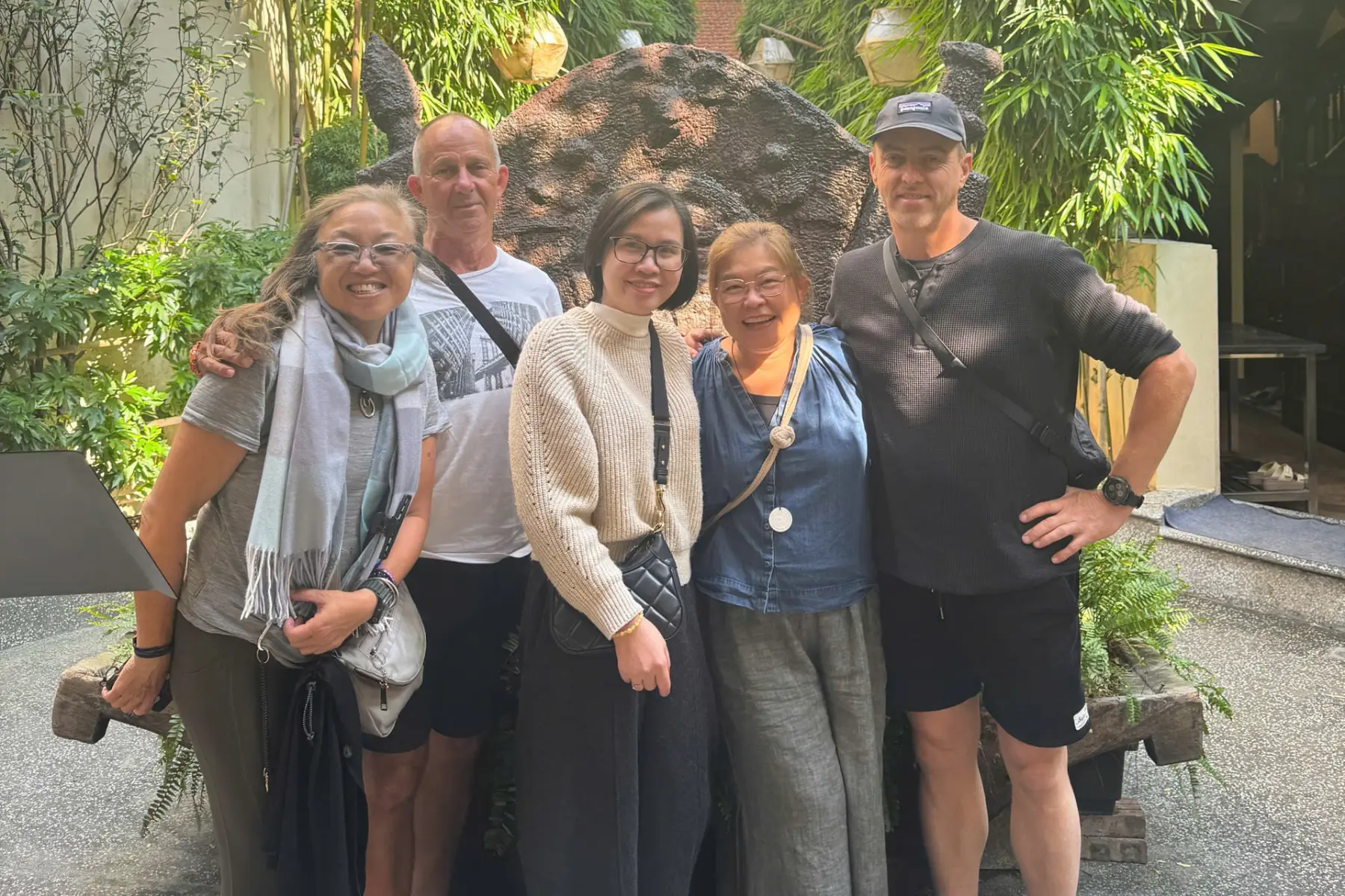Local guide Tracy posing with international travelers during a lunch break in Vietnam