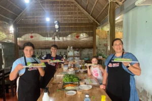 Tourists preparing Vietnamese spring rolls during a cooking class in Hoi An Vietnam