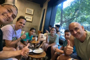 Tourist family relaxing at a coffee shop in Hanoi Old Quarter Vietnam